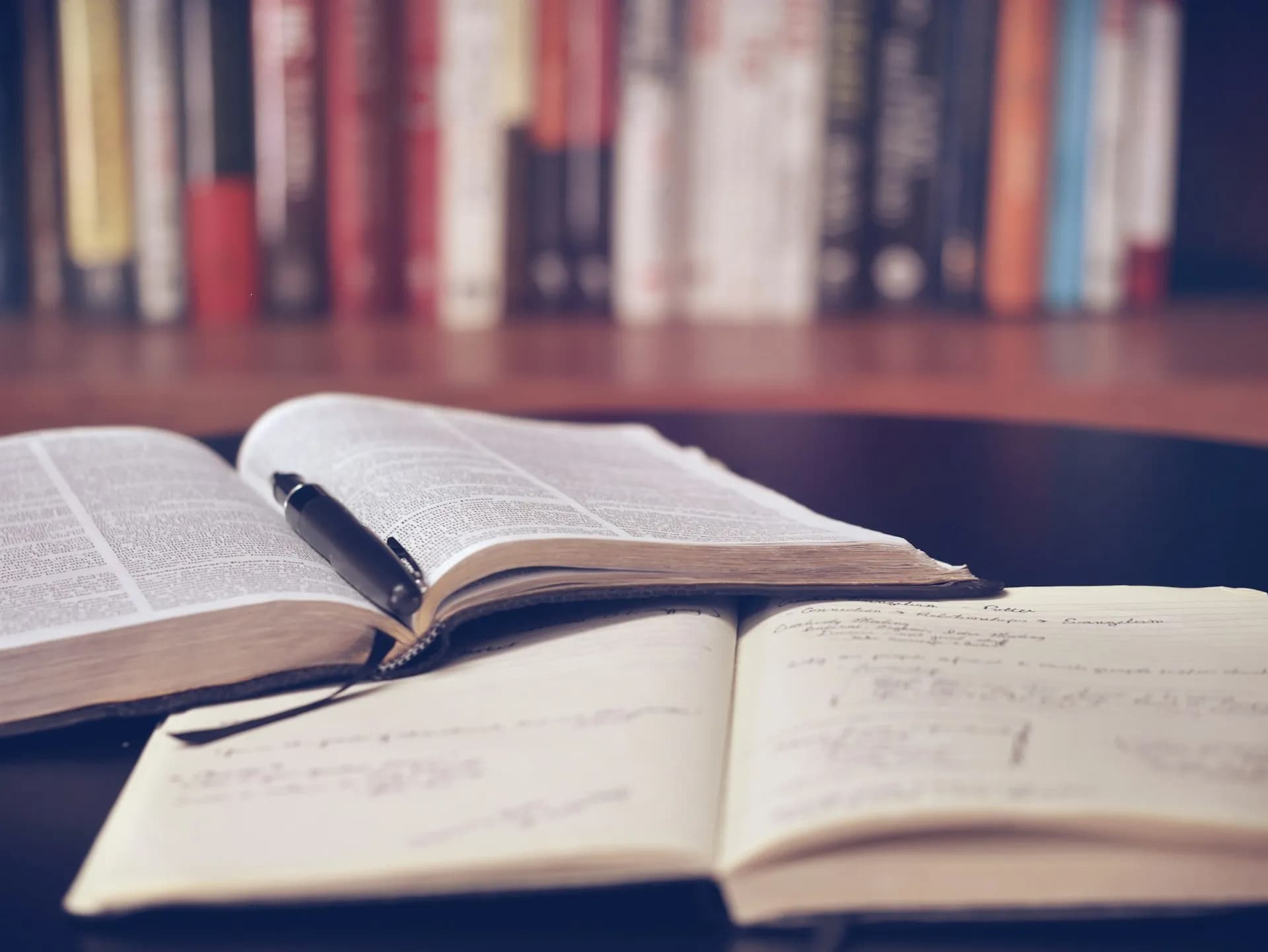 A book and a notebook on a desk